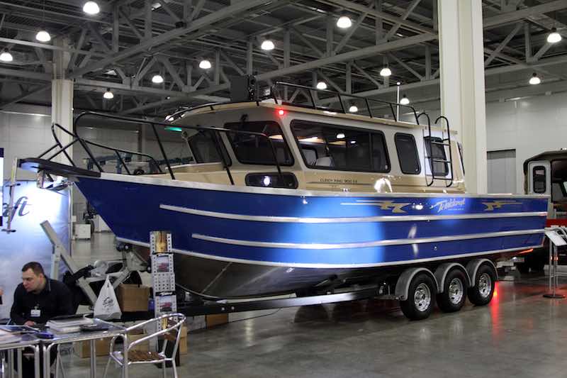 Big aluminum boat on a three-axle boat trailer