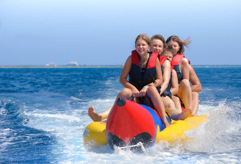Group of girls on a banana boat ride experience