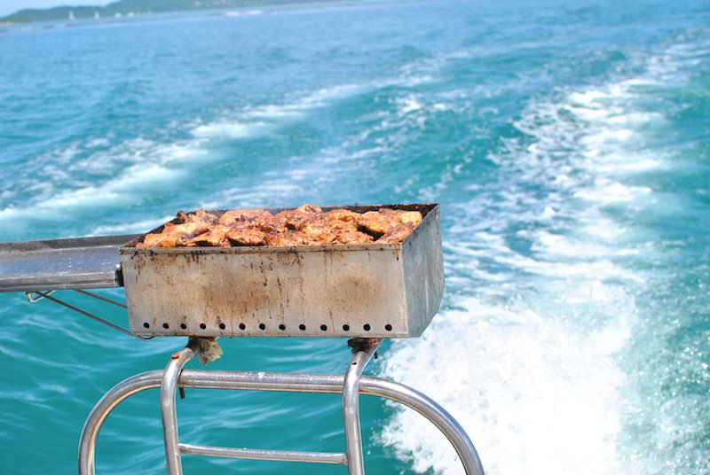 Fresh fish meat grilled on a boat grill