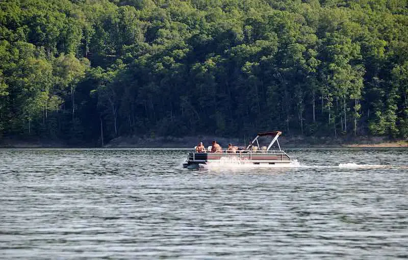 Large Group of People on a Pontoon Boat on a Lake