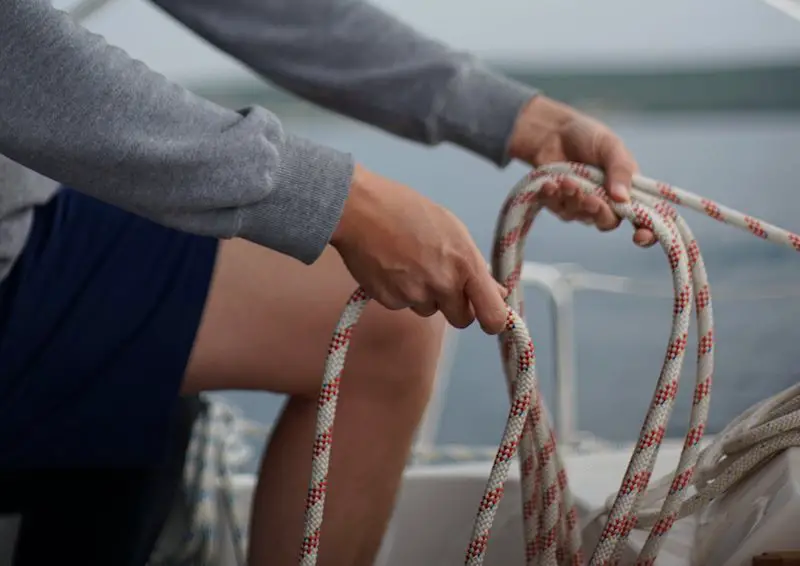 Man working with ropes on a boat. Personal Hygiene on boat