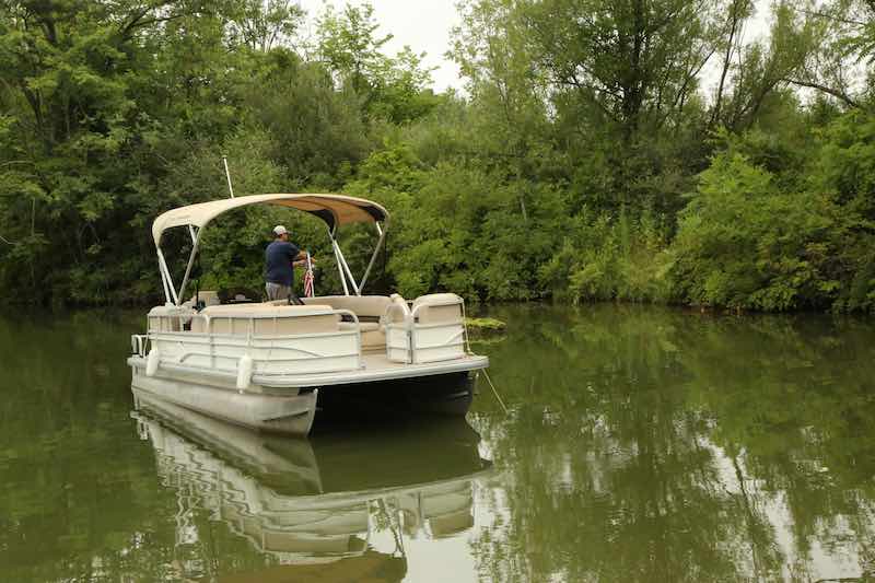 Man Fishing For Bass on a Pontoon Boat in Florida