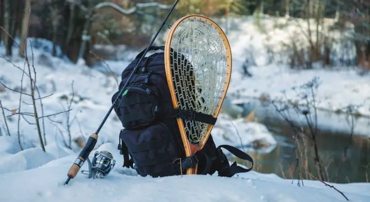 A Fishing backpack on a snowy river bed